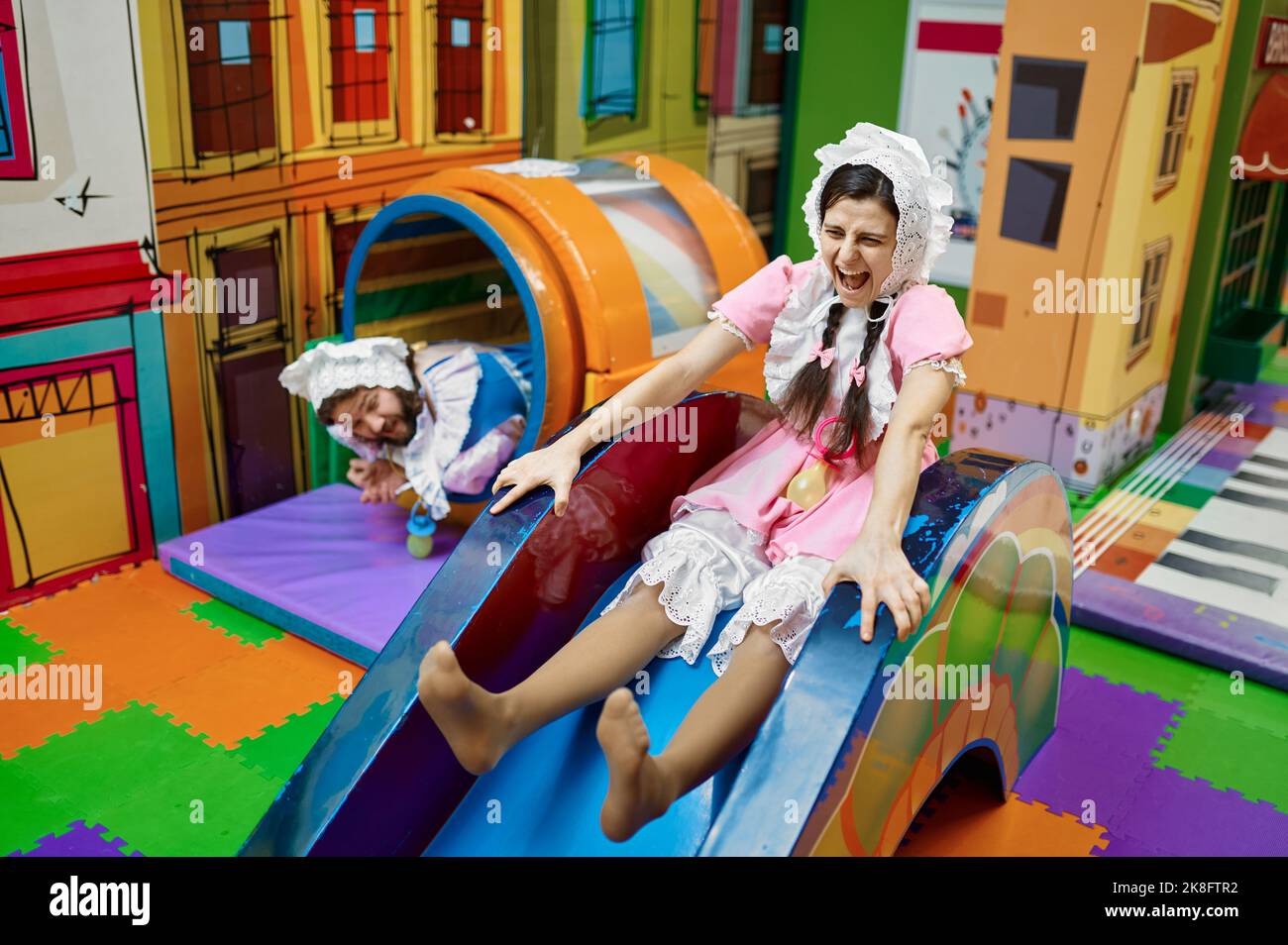 Happy funny man and woman newborn baby in daycare center Stock Photo