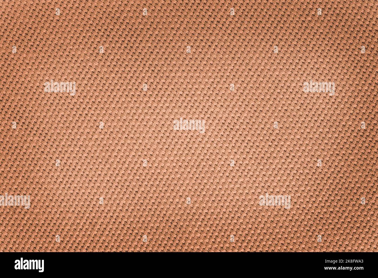 close up of blank brown canvas texture enlighted at centre Stock Photo