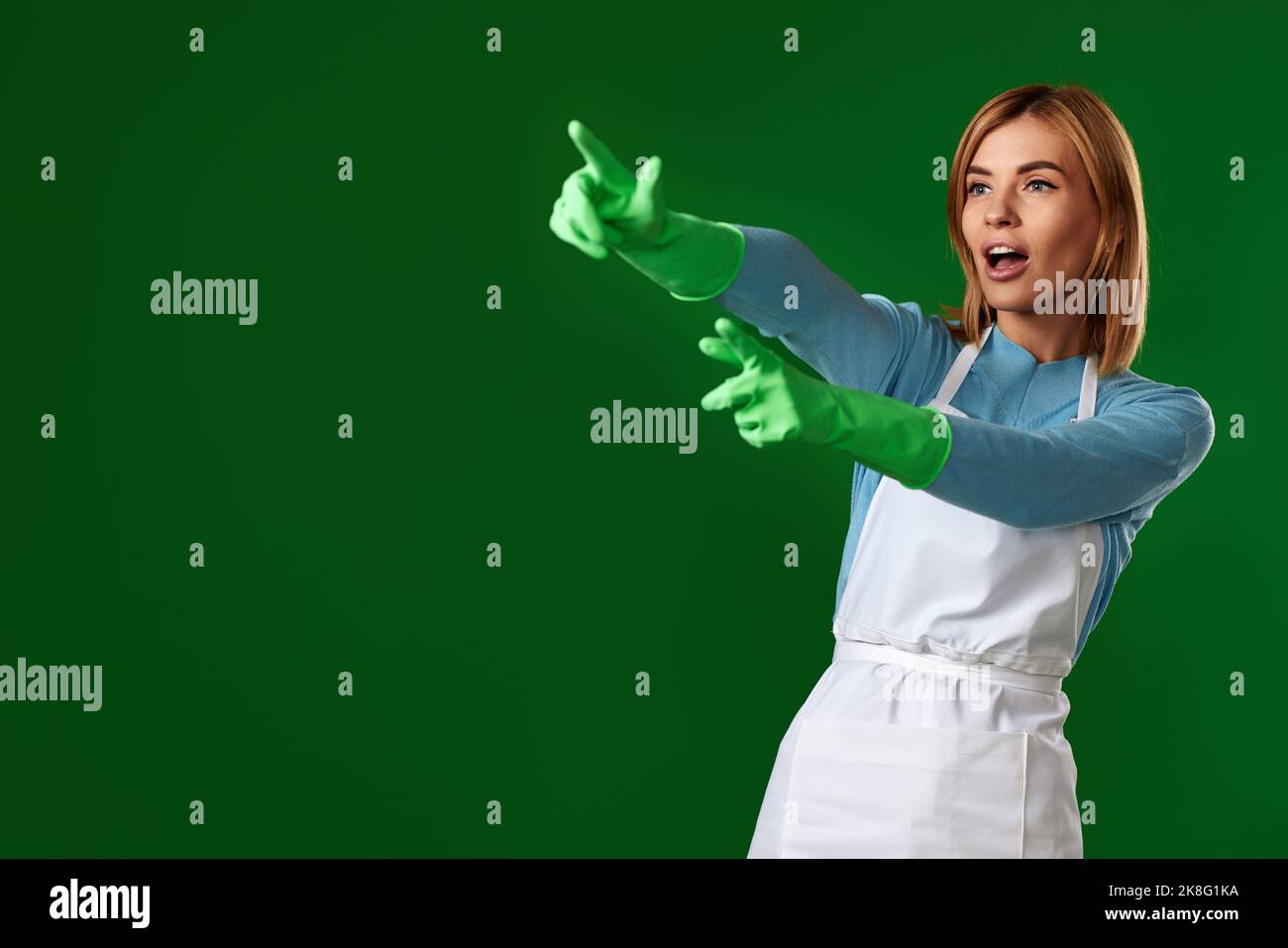 woman in gloves pointing fingers at copy space Stock Photo