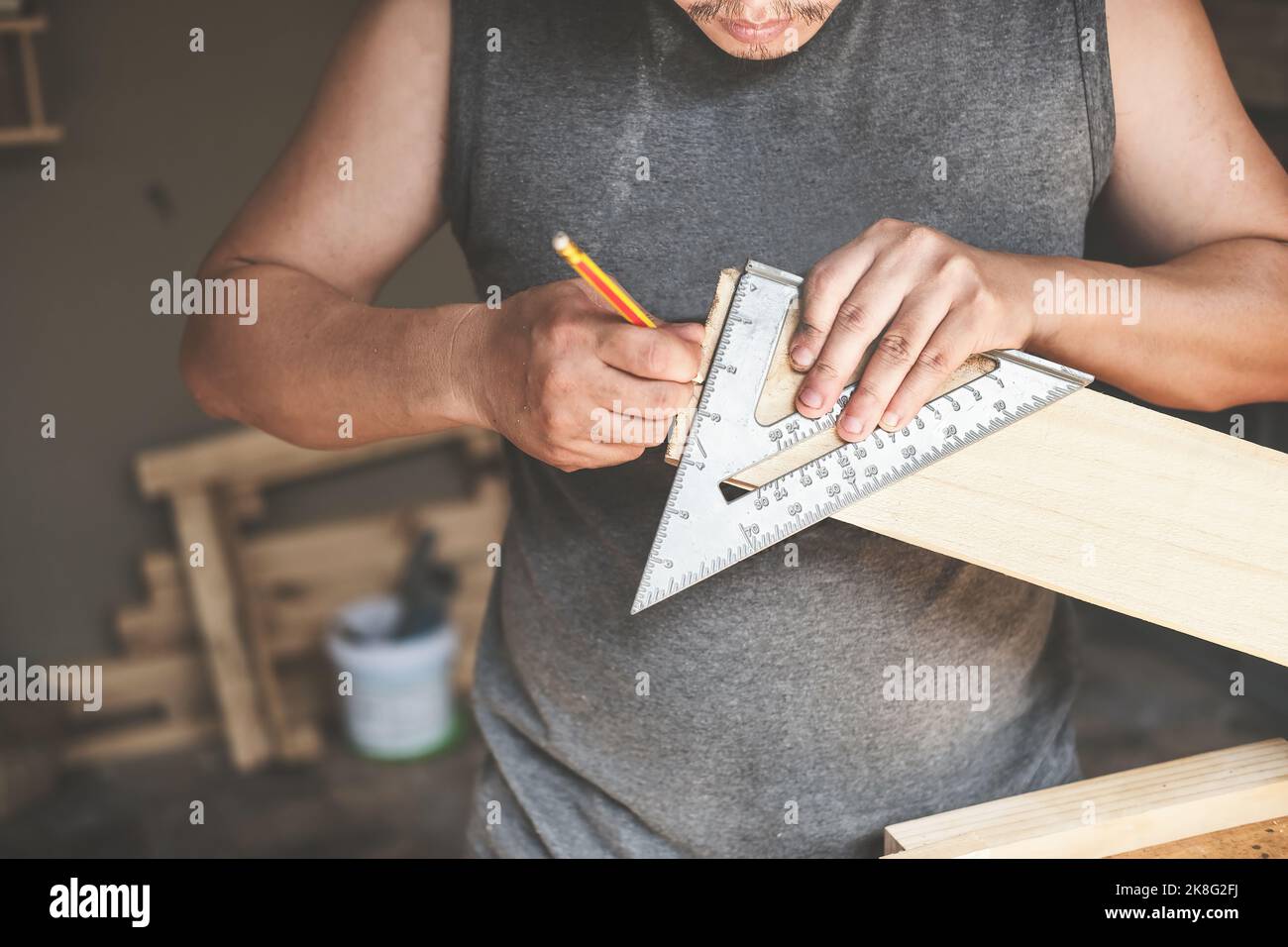 A carpenter measures the plates to assemble the parts. and build a