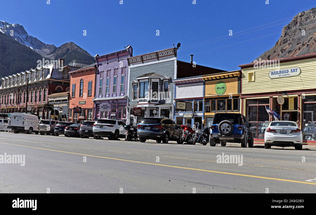 Greene Street with hotels, shops, eateries, and views of the San Juan Mountains in this historic old west mountain mining town in Silverton, Colorado. Stock Photo