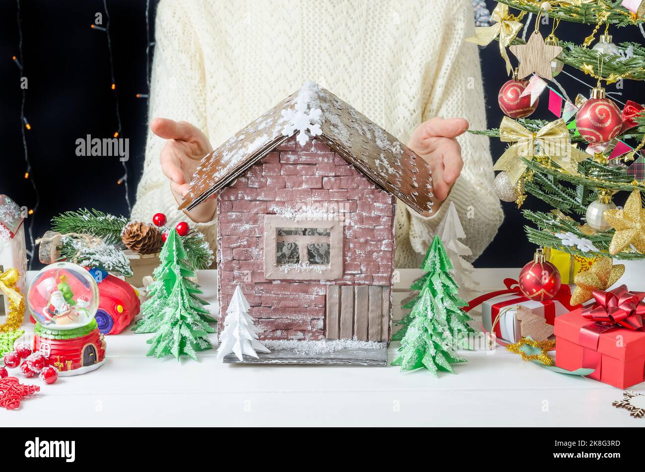 Step-by-step photo instructions for making a Christmas decor, step 9 -  ready-made painted cardboard house Stock Photo - Alamy