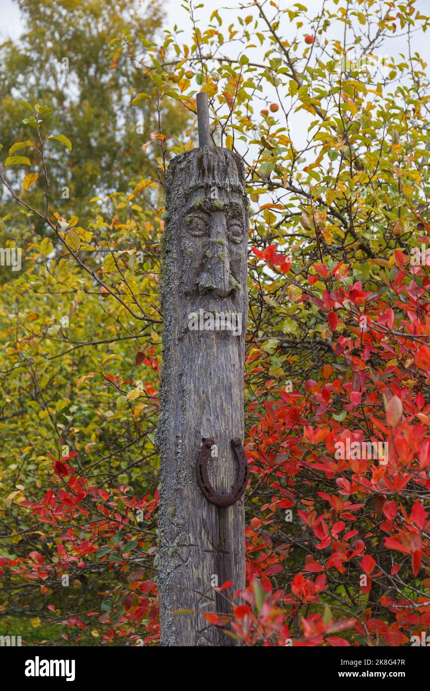 Carved wooden post, man creature in Estonia Stock Photo - Alamy