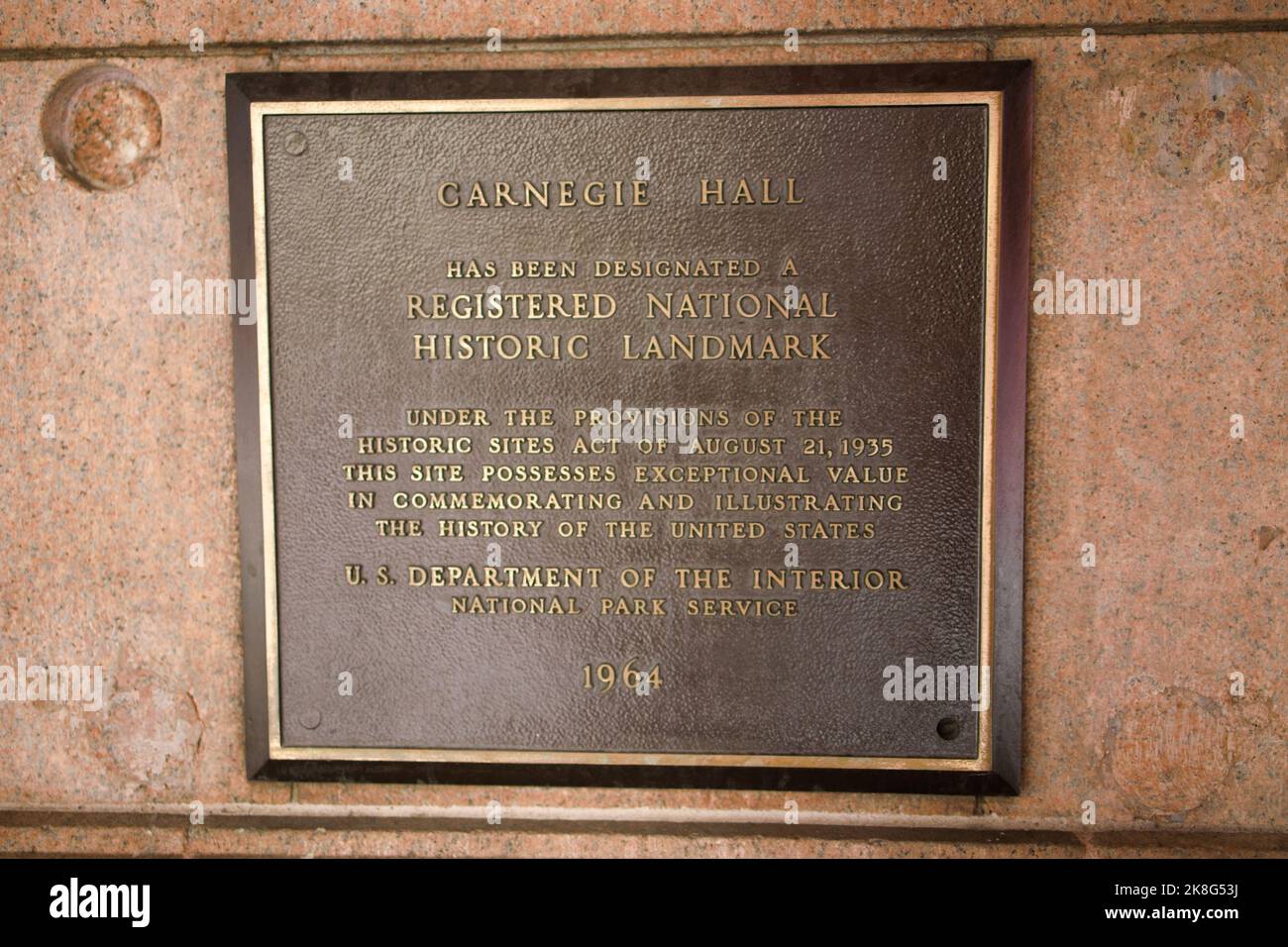 New York, NY, USA - Oct 23, 2022: A metallic sign fixed to outside wall of Carnegie Hall indicating National Landmark status as of 1964. Stock Photo