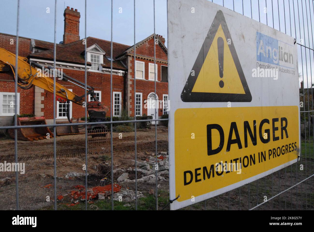 Danger demolition sign and excavator at site of Luxury Red House, demolished as thought unsafe due to coastal erosion. Thorpeness 22 October 2022 Stock Photo