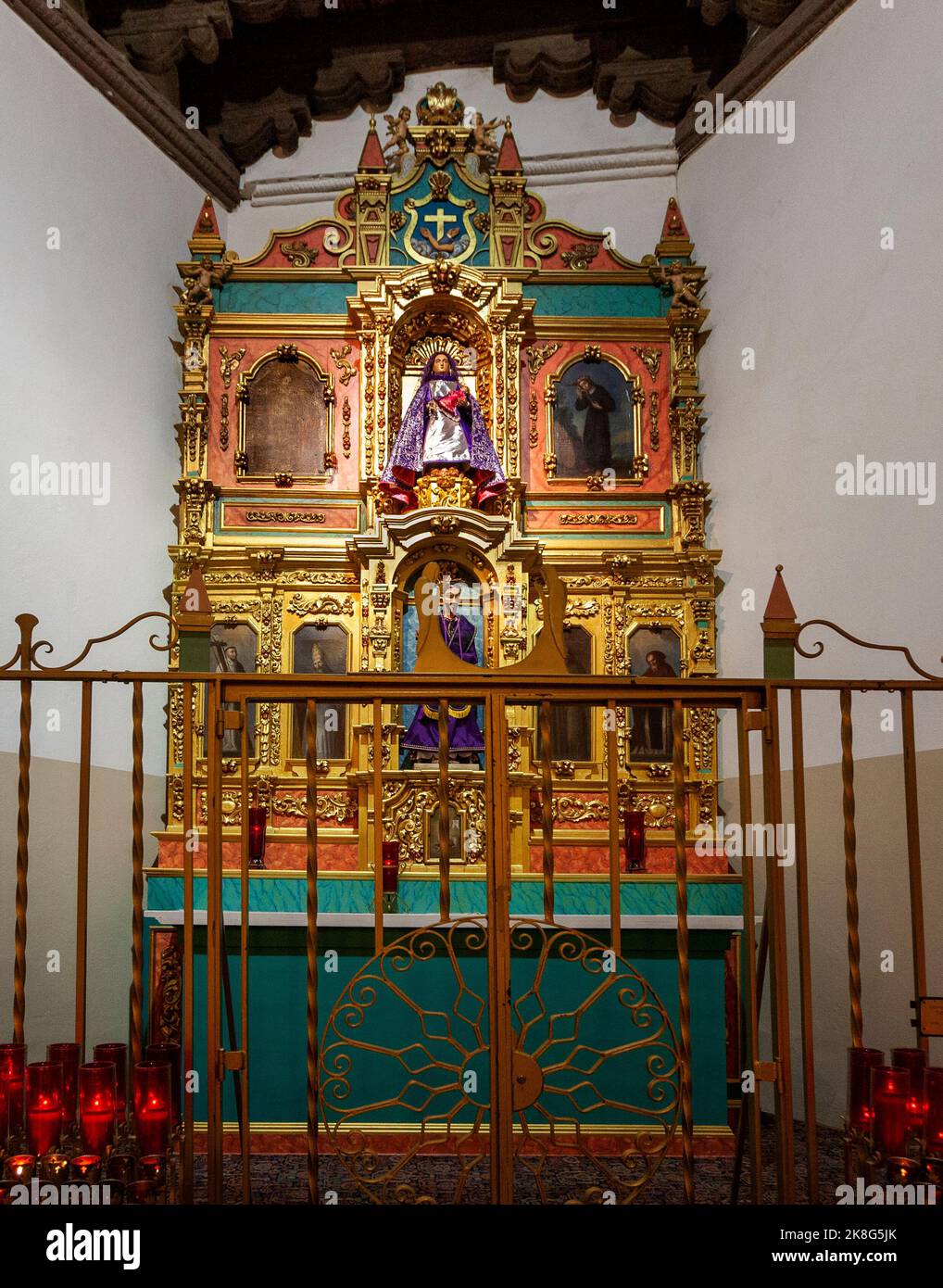 Altarpiece in the La Conquistadora Chapel is in the north transept of the Cathedral Basilica of Saint Francis of Assisi in Santa Fe, New Mexico.  The Stock Photo