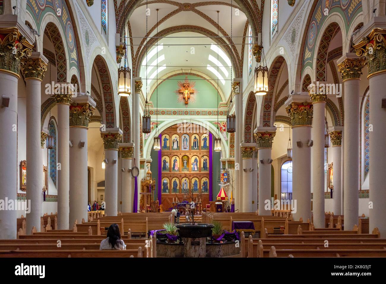 The nave and sanctuary of 19th century Cathedral Basilica of Saint Francis of Assisi - Catedral basílica de San Francisco de Asís in Santa Fe, NM Stock Photo