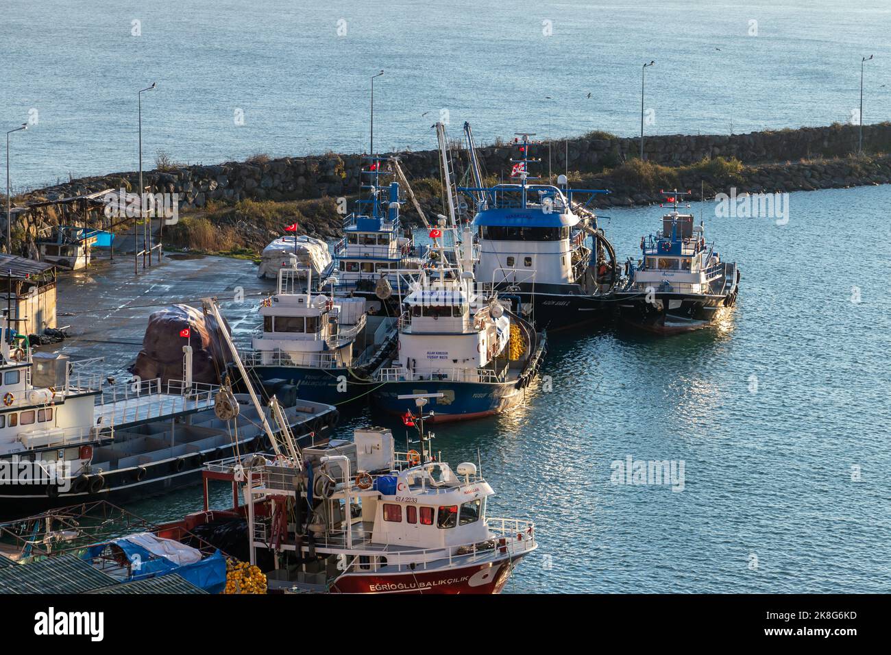 Surmene, Turkey - December 23, 2021: Fleet of fishing boats moored in harbor of Arakli Stock Photo