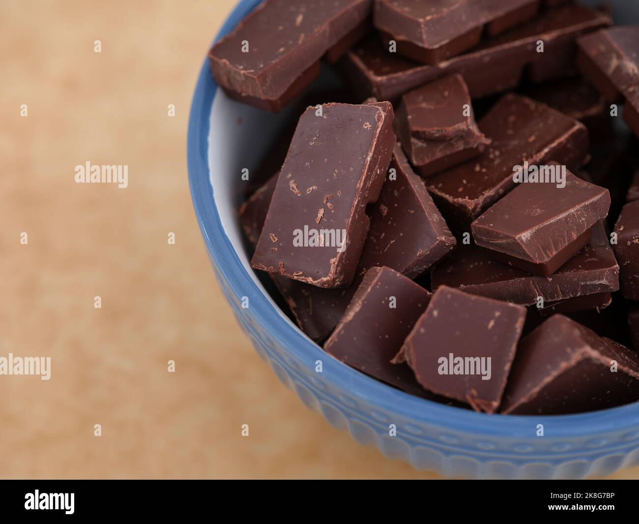 A bowl of broken dark chocolate. Close up. Stock Photo