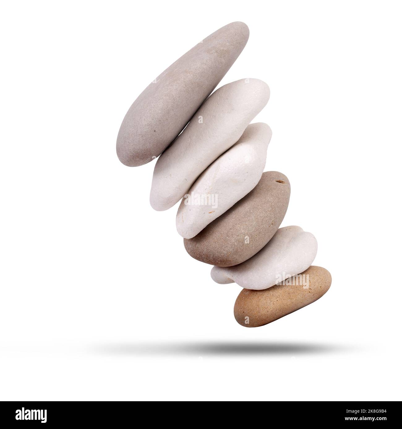 Stack of beech stones falling over isolated on a white background Stock Photo