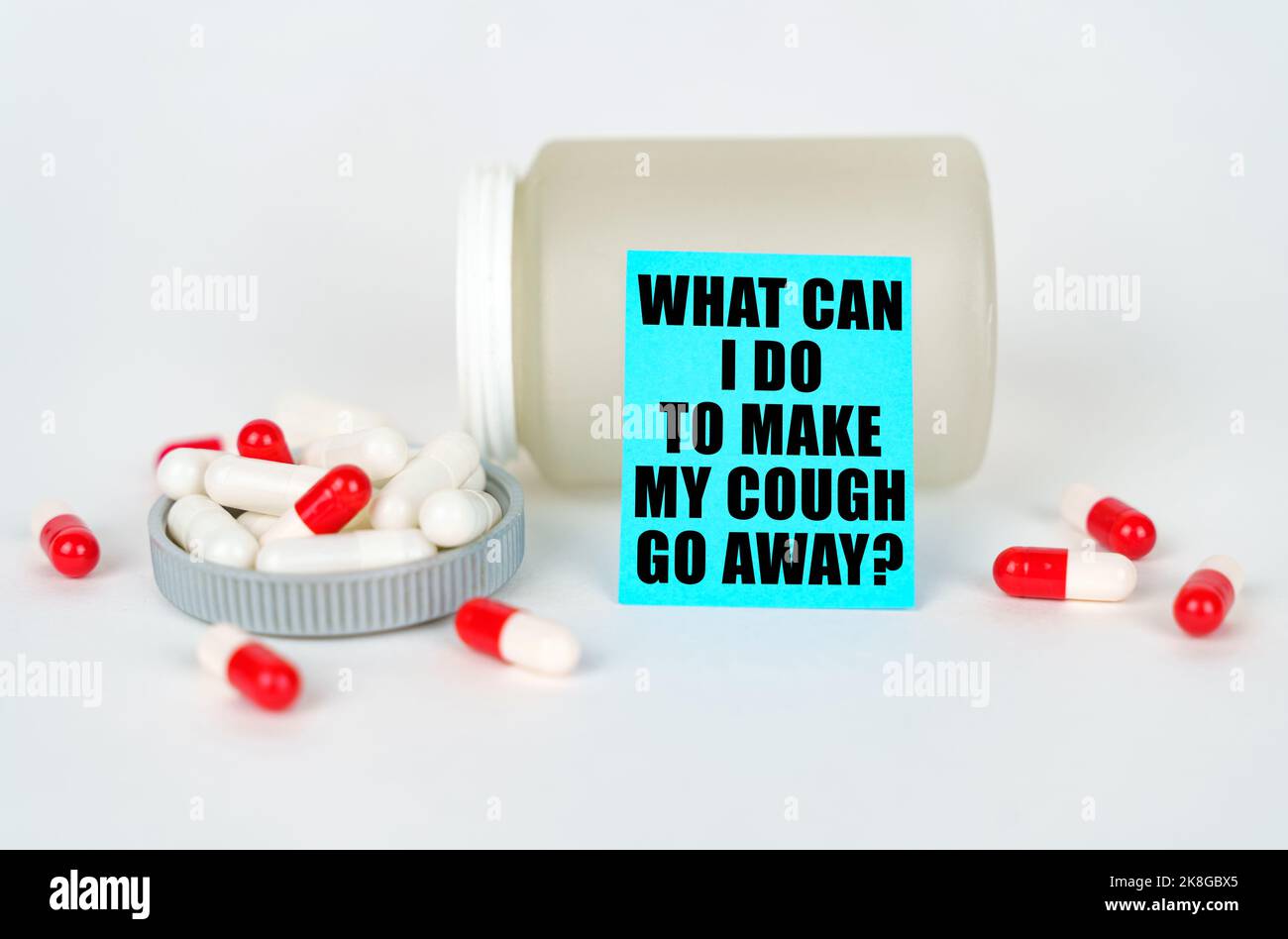 Medical concept. On a gray background, a jar, capsules and a sign with