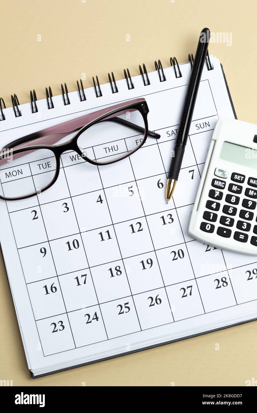 Calculator and calendar with reporting days Stock Photo Alamy