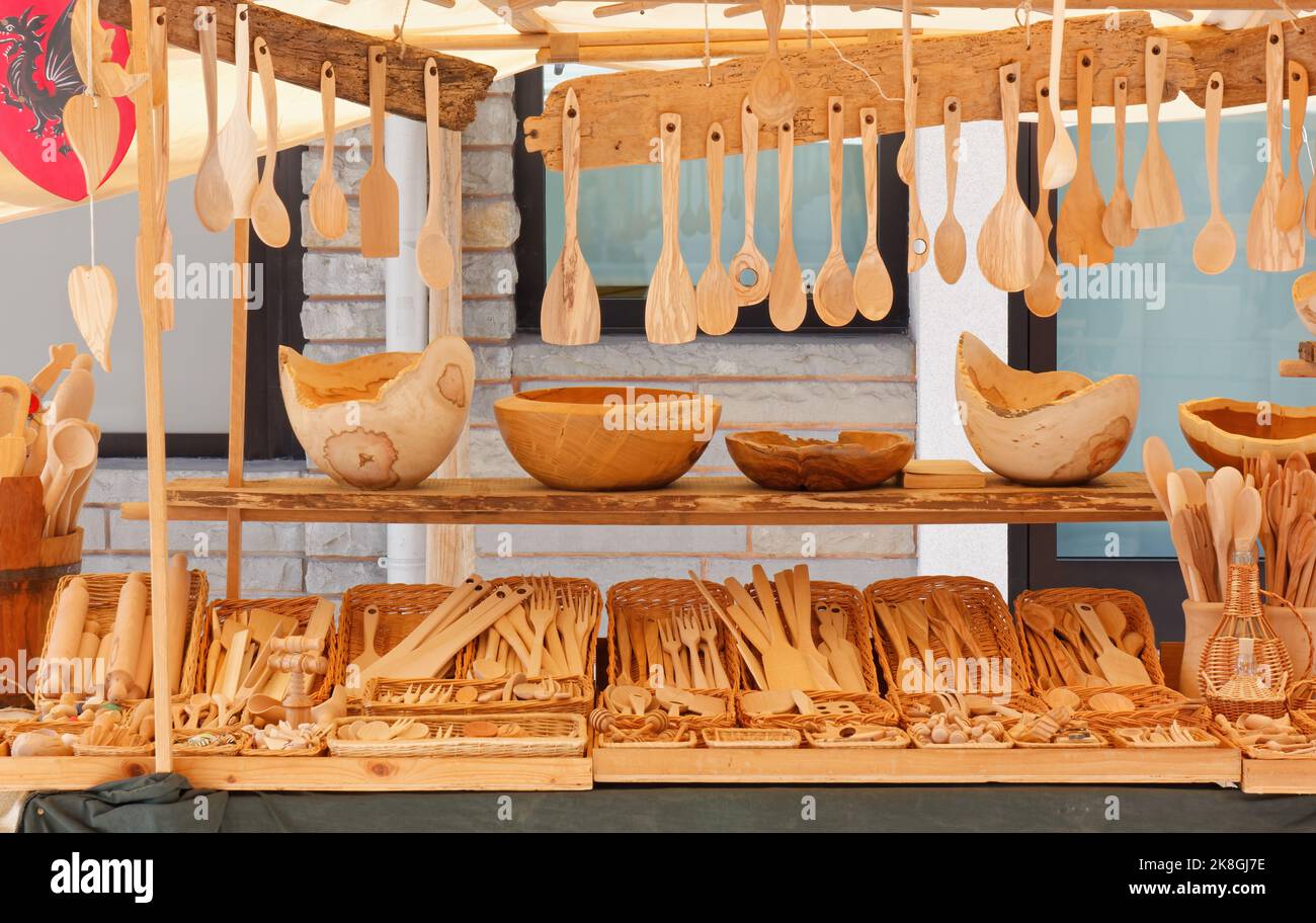 Stand at a street market selling wooden kitchen utensils as bowls, ladles and cutlery Stock Photo