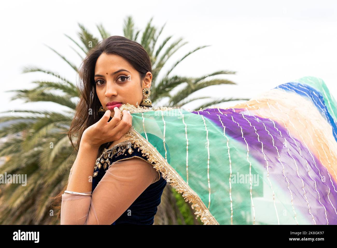 Side view of young ethnic woman with long hair in traditional sari ...