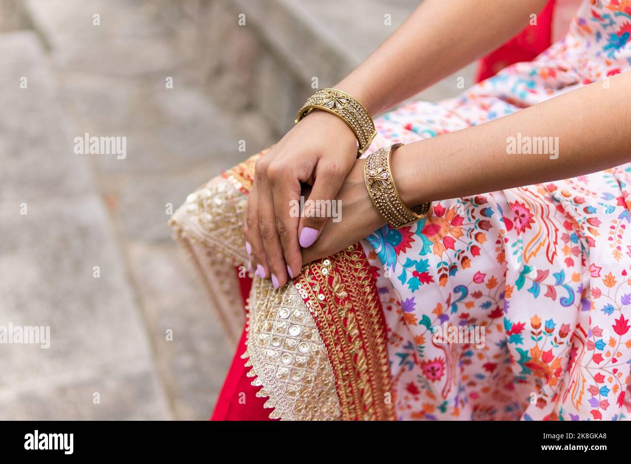 High angle of crop anonymous Indian female in ornamental clothes with