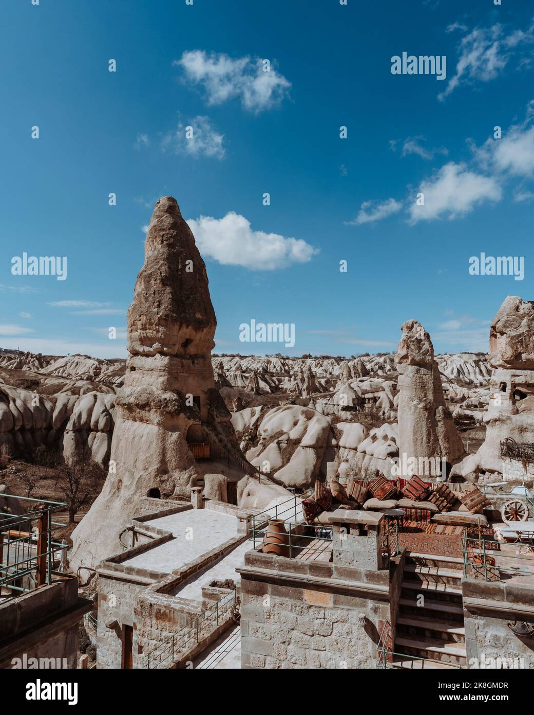 Amazing scenery of ancient town with massive rocky fairy chimney houses against bright blue sky on sunny day in Cappadocia Turkey Stock Photo