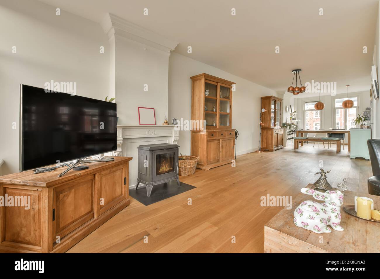 Modern interior of dining room with television next to bright window