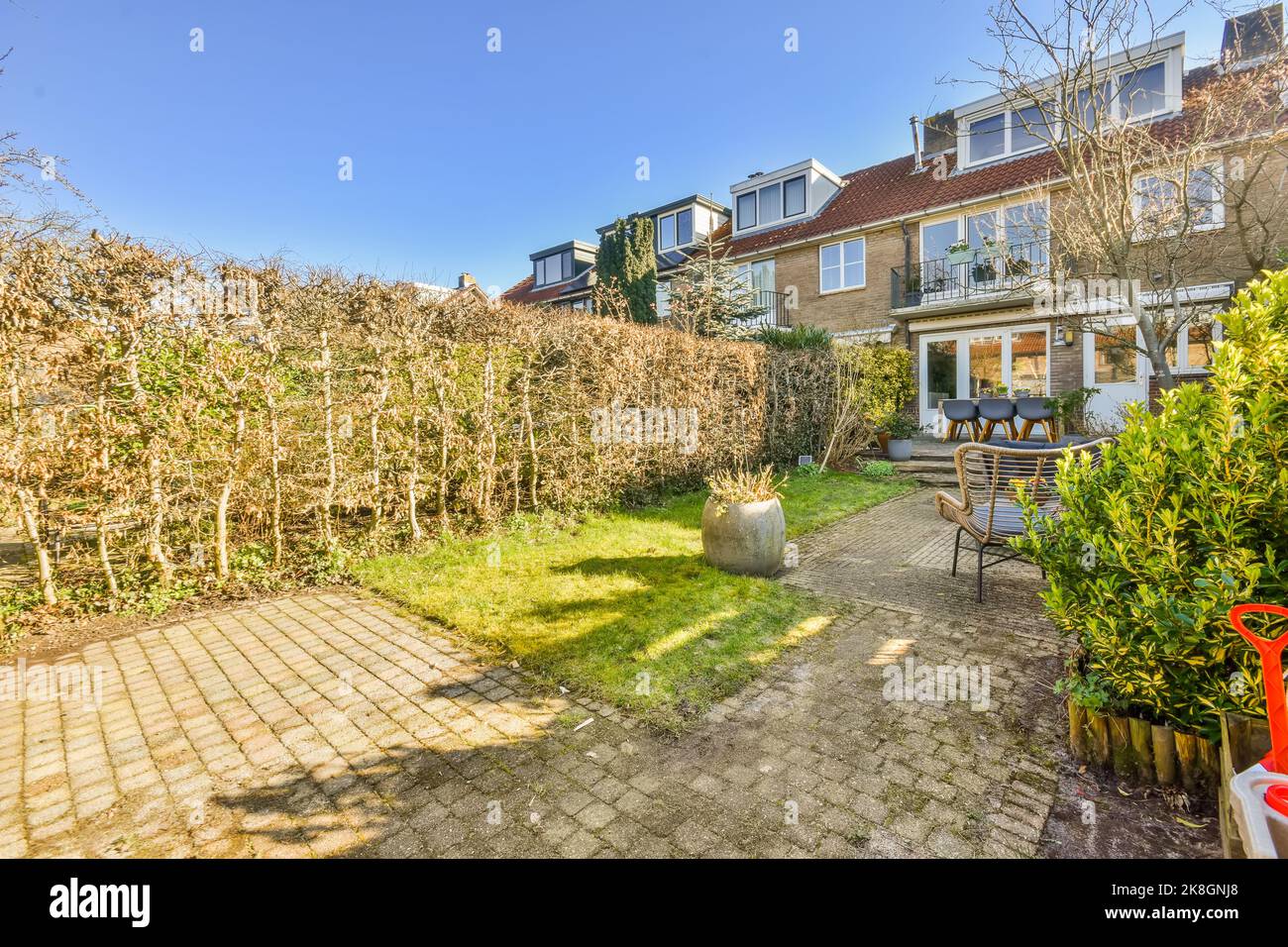 Terrace of residential building with grassy lawn and green trees ...