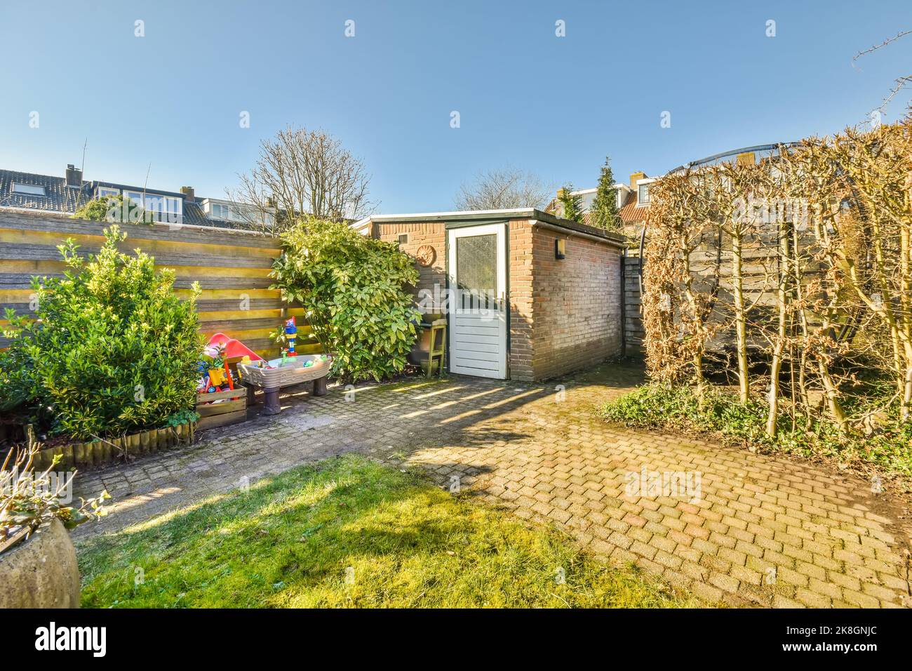 Terrace of residential building with grassy lawn and green trees ...