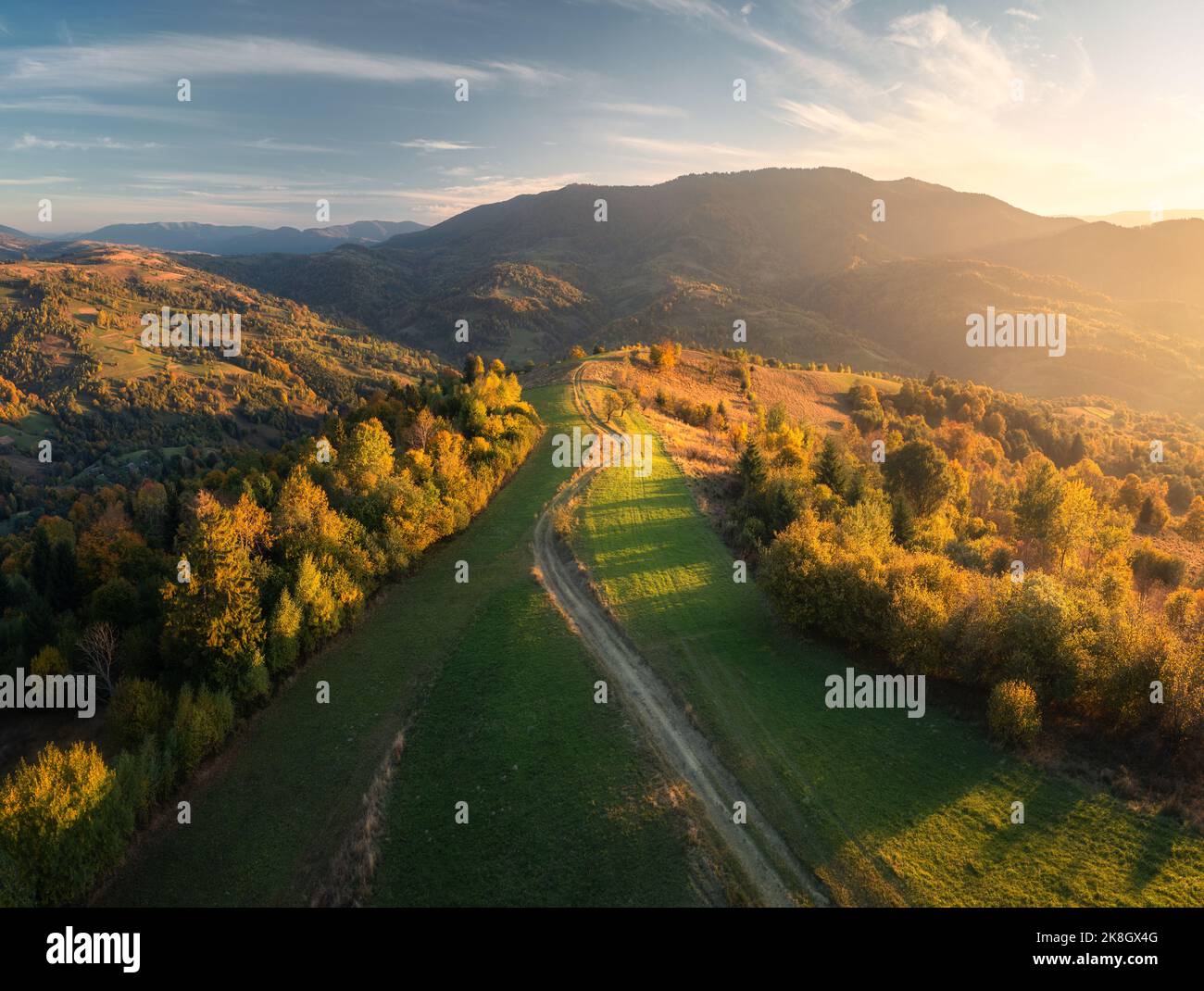 Aerial view of green hills, forest and mountains in autumn Stock Photo
