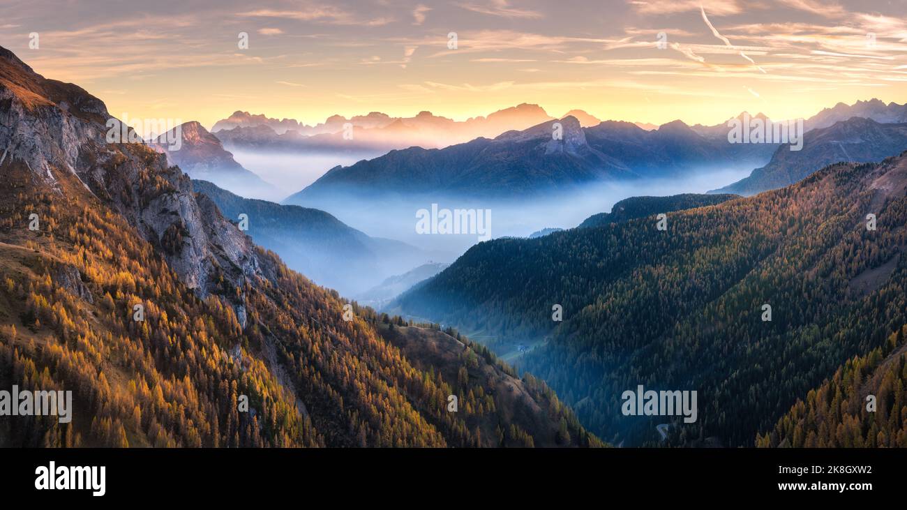 Mountains in low clouds at beautiful sunset in autumn in Italy Stock Photo