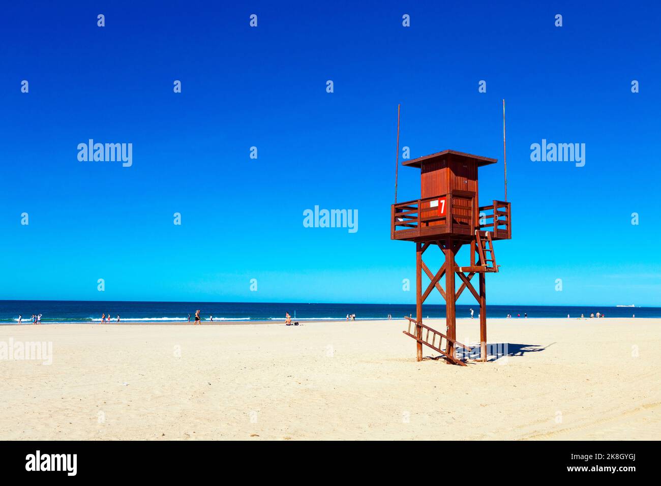 Red wooden lifeguard tower at Playa de la Barrosa, Cadiz, Spain Stock Photo