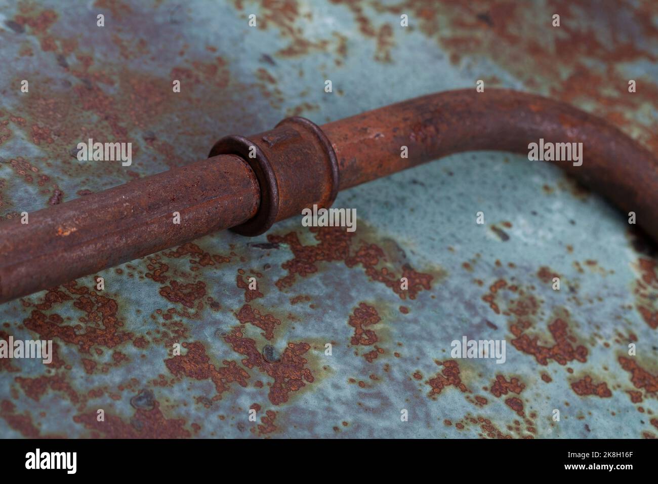 Old rusty valve pipes on rusty metal wall background Stock Photo - Alamy