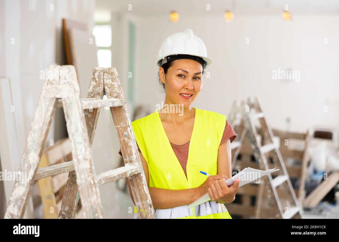 Woman construction worker with project documentation Stock Photo