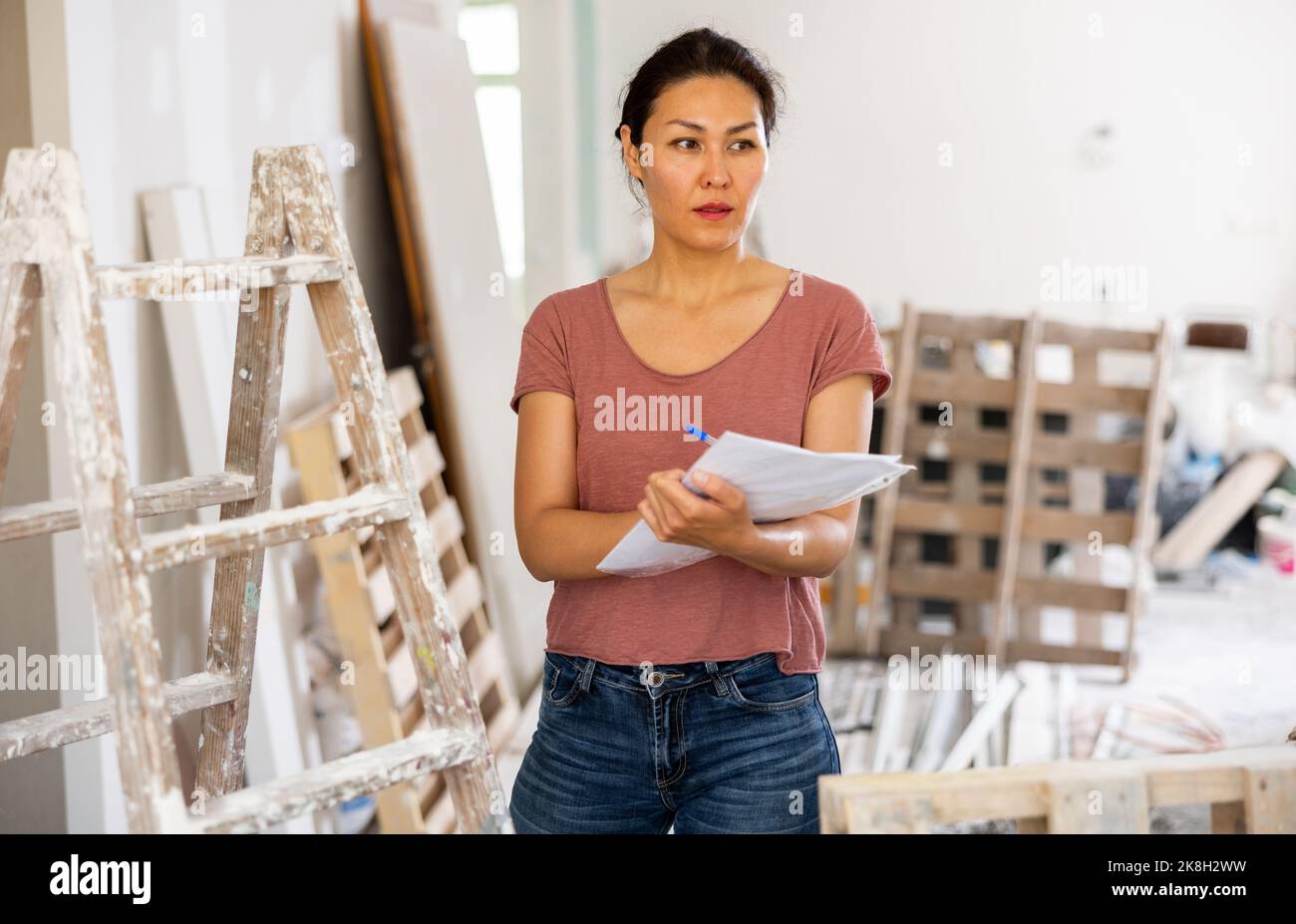 Woman construction manager checking project documentation Stock Photo