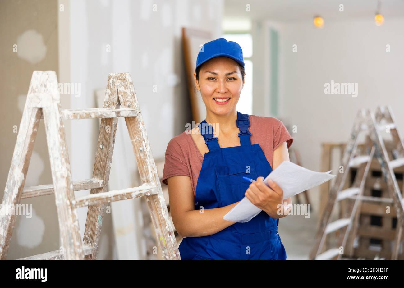 Woman construction worker with project documentation Stock Photo