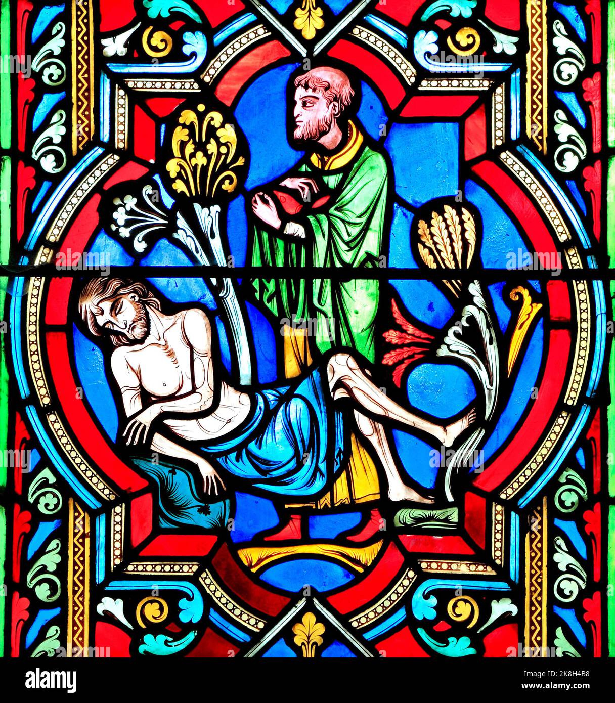 The Good Samaritan Parable, a Priest 'passes by on the other side', ignoring dying traveller, stained glass window, by Oudinot of Paris,1859, Feltwell Stock Photo