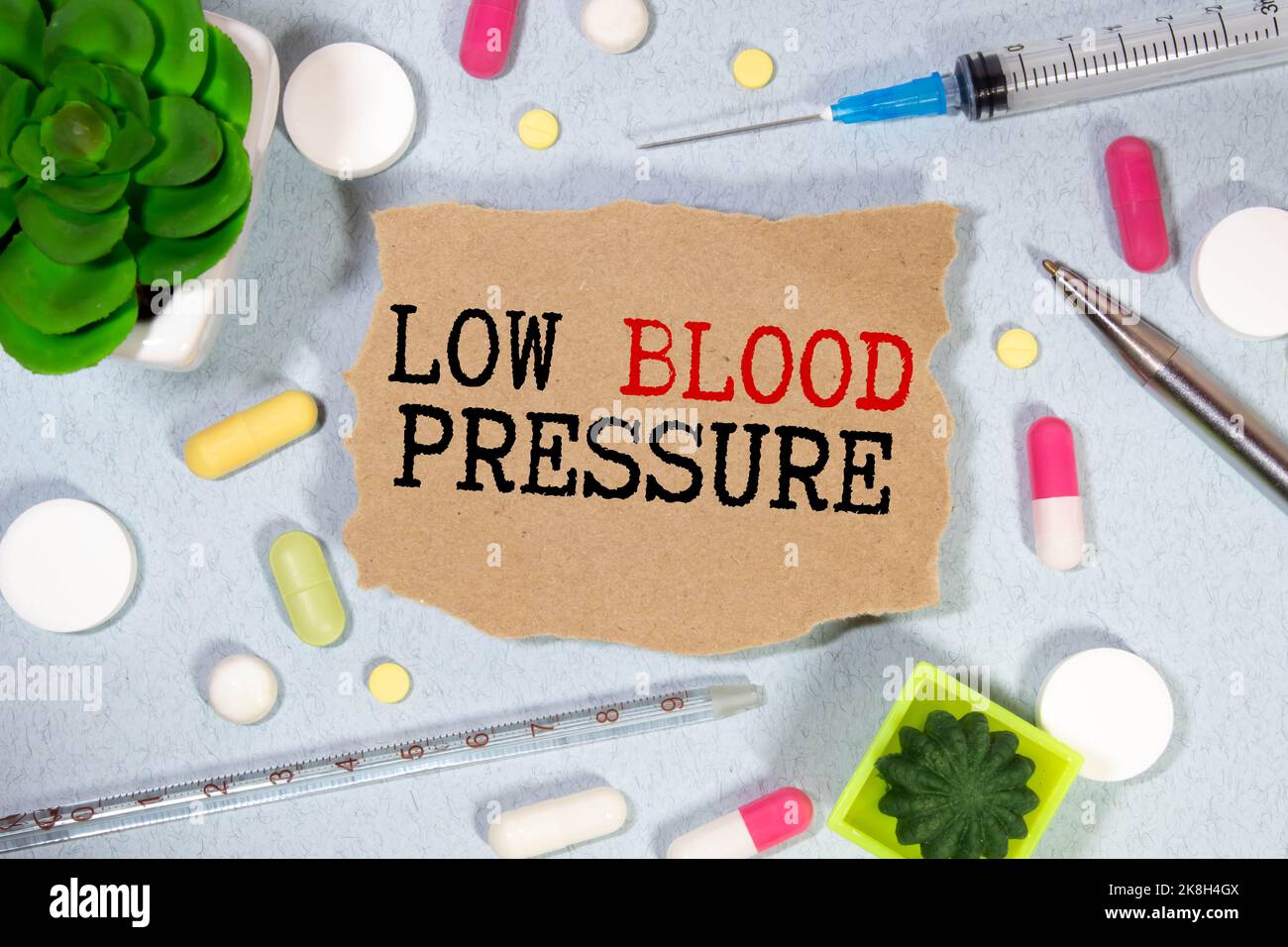 Low Blood Pressure word, medical term word with medical concepts in blackboard and medical equipment background Stock Photo