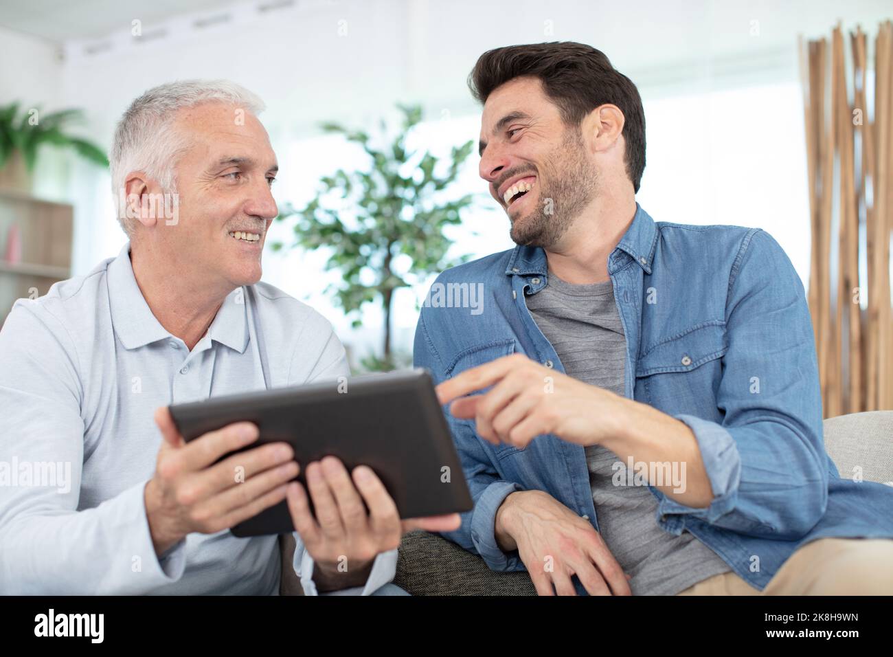 senior father and young son with tablet Stock Photo