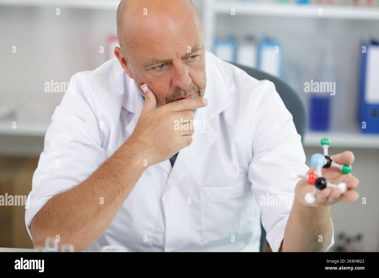 man scientist holding an atom model Stock Photo