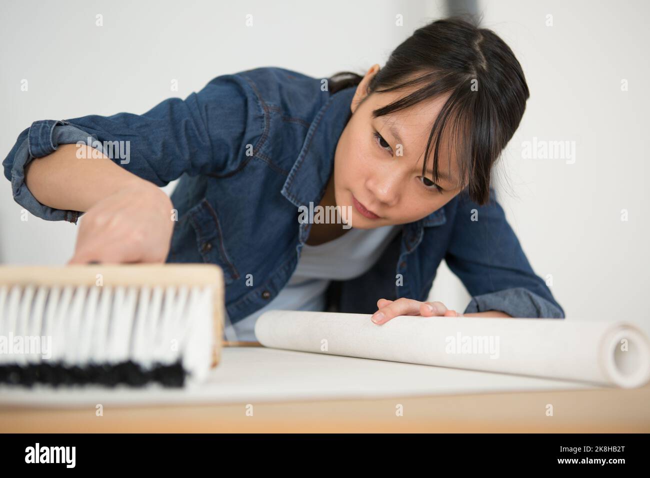 woman preparing for wallpaper work Stock Photo