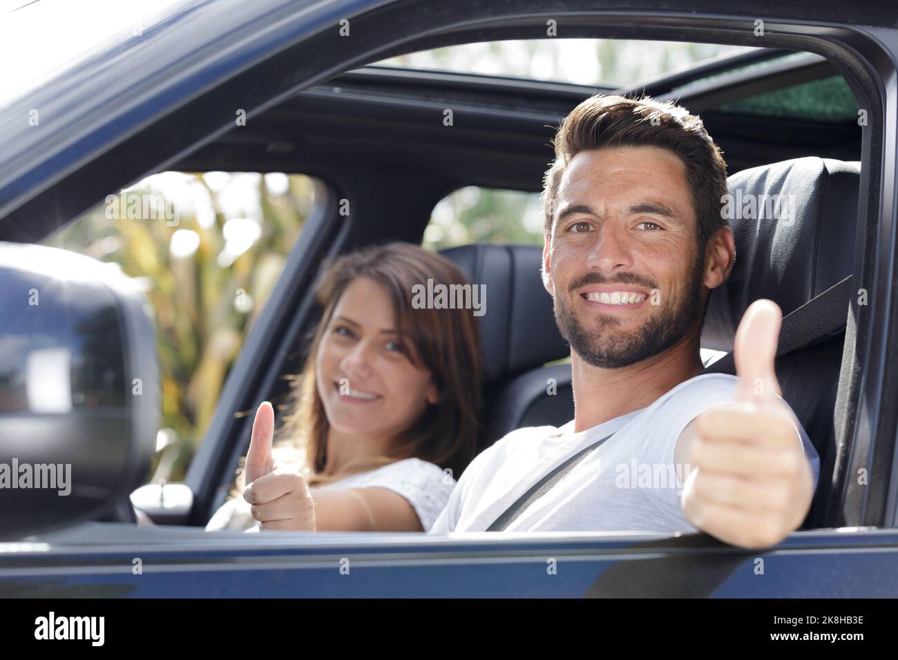 Happy girl in car thumb hi-res stock photography and images - Alamy