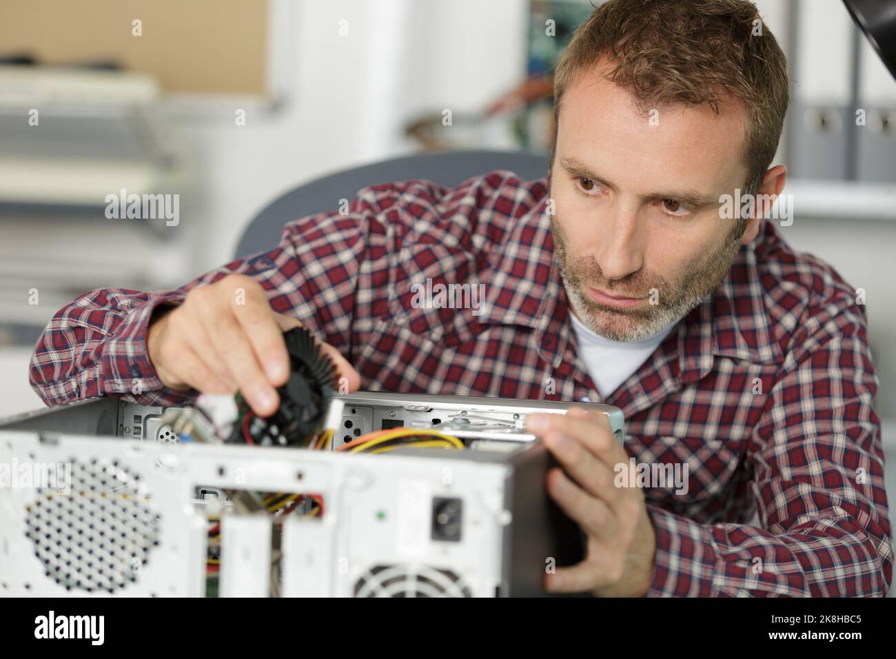 computer repairman specialist repairing computer desktop Stock Photo