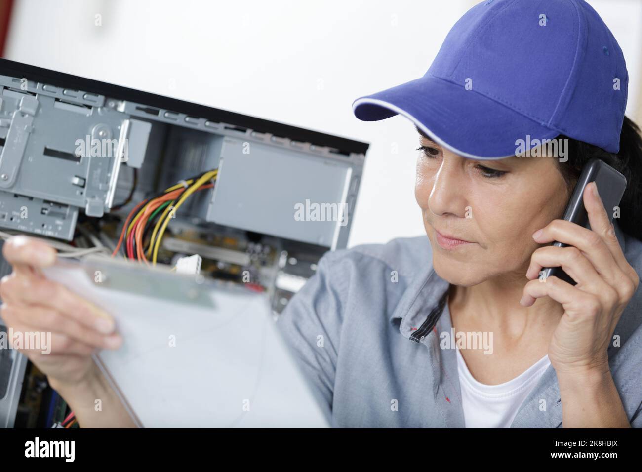 female engineer repairs the laptop Stock Photo