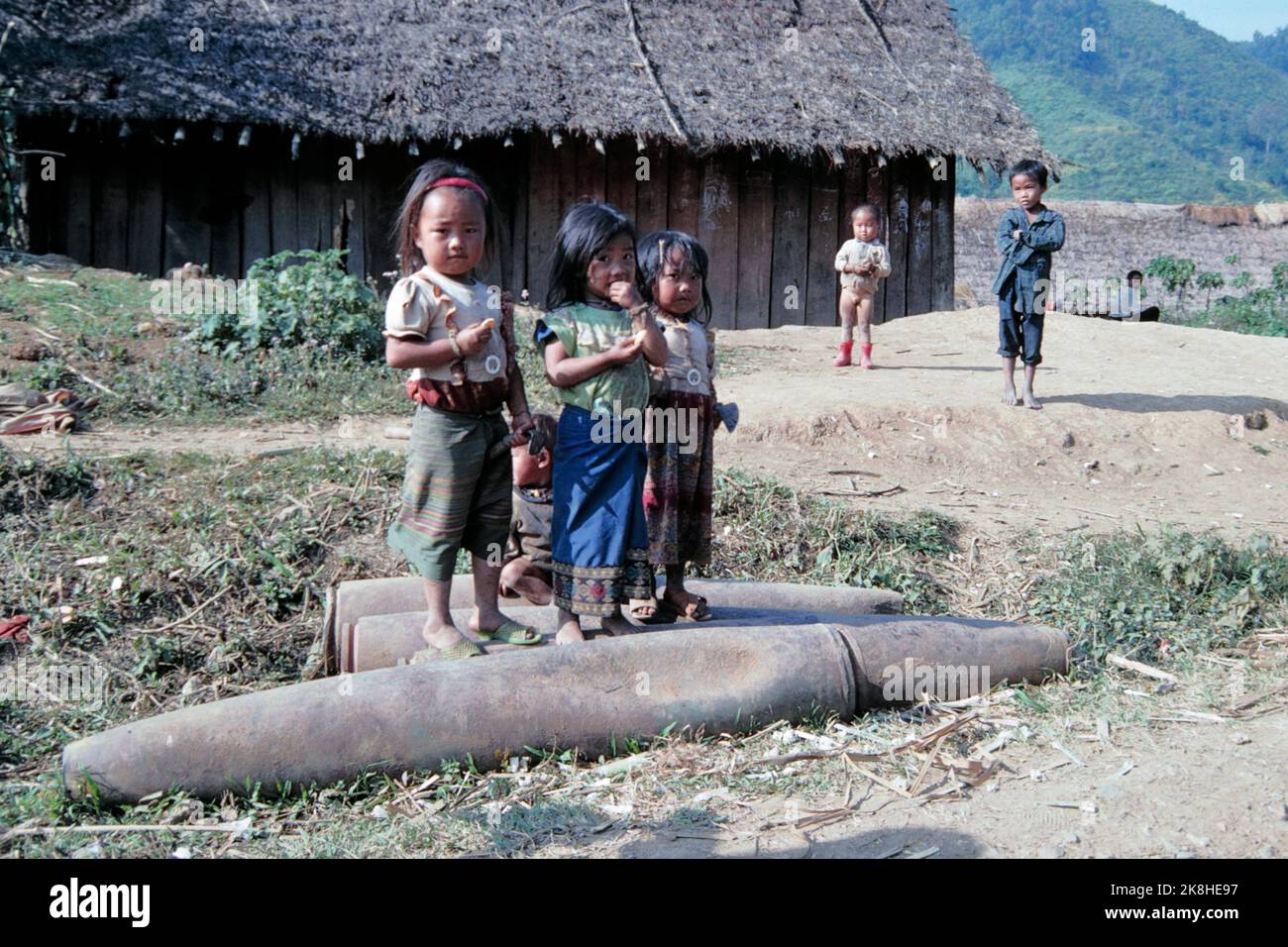US-made cluster bomb casings collected and placed at roadside scrap yard, Plain of Jars, Laos 1997 Stock Photo