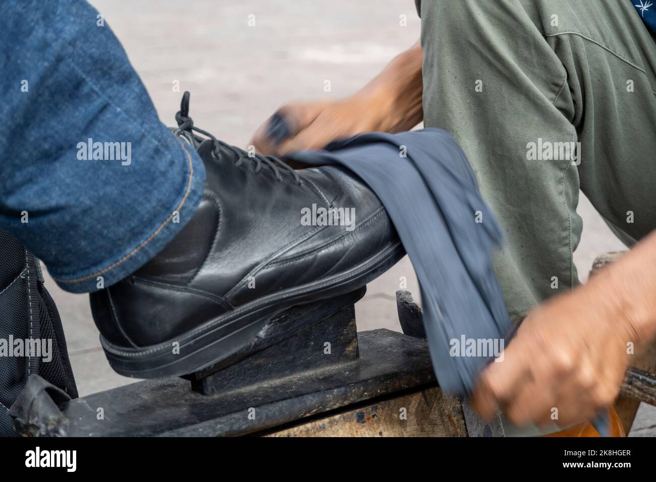 shoes in a wash basin with soapy water. cleaning the shoes at street
