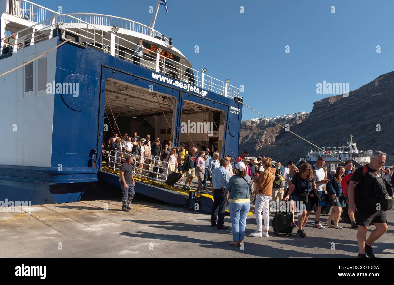 Ormos Athinios, Santorini, Greece. 2022. Athinios Port, Santorini Island for ferries and cargo ships. Passengers disembarking from a ferry arriving fr Stock Photo