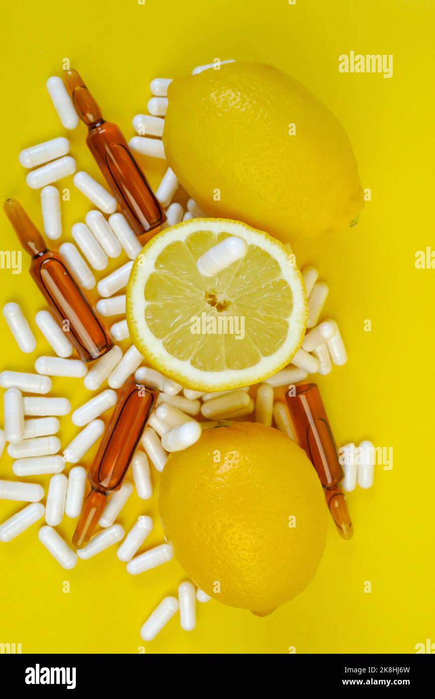 Vitamin C tablets on a yellow background.Lots of pills and citrus