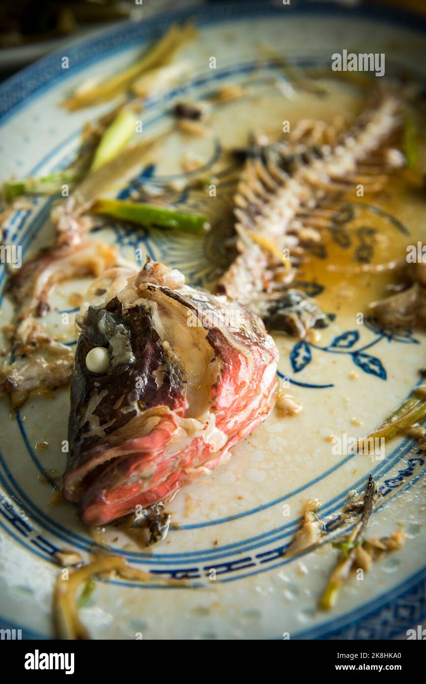 Remains of a steamed fish with ginger and spring onions at Wah Kee seafood restaurant, Mui Wo Lantau Island, Hong Kong Stock Photo