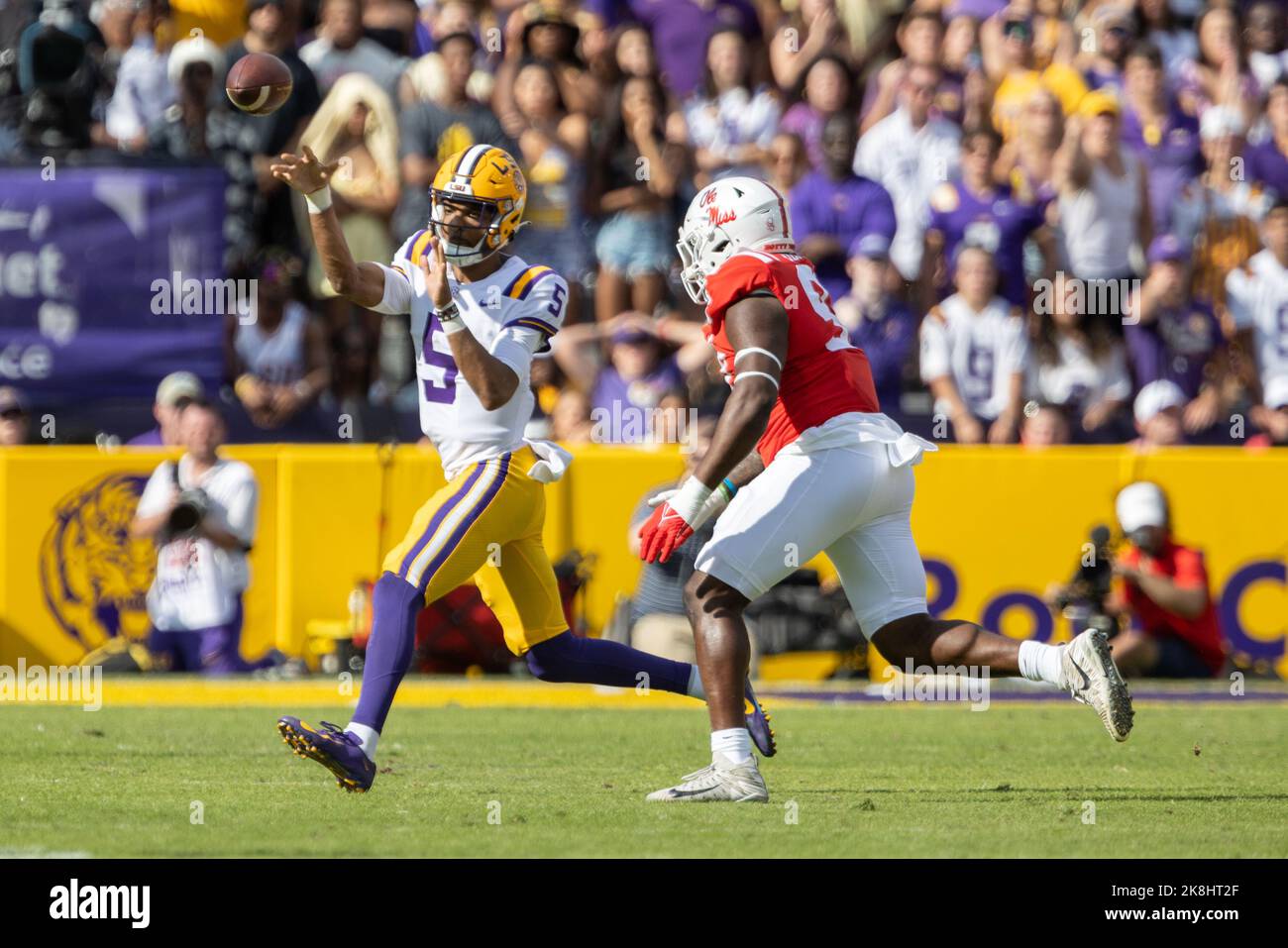 LSU Tigers quarterback Jayden Daniels (5) gets a pass off before Ole Miss Rebels defensive tackle Jamond Gordon (97) can make the tackle, Saturday, Oc Stock Photo