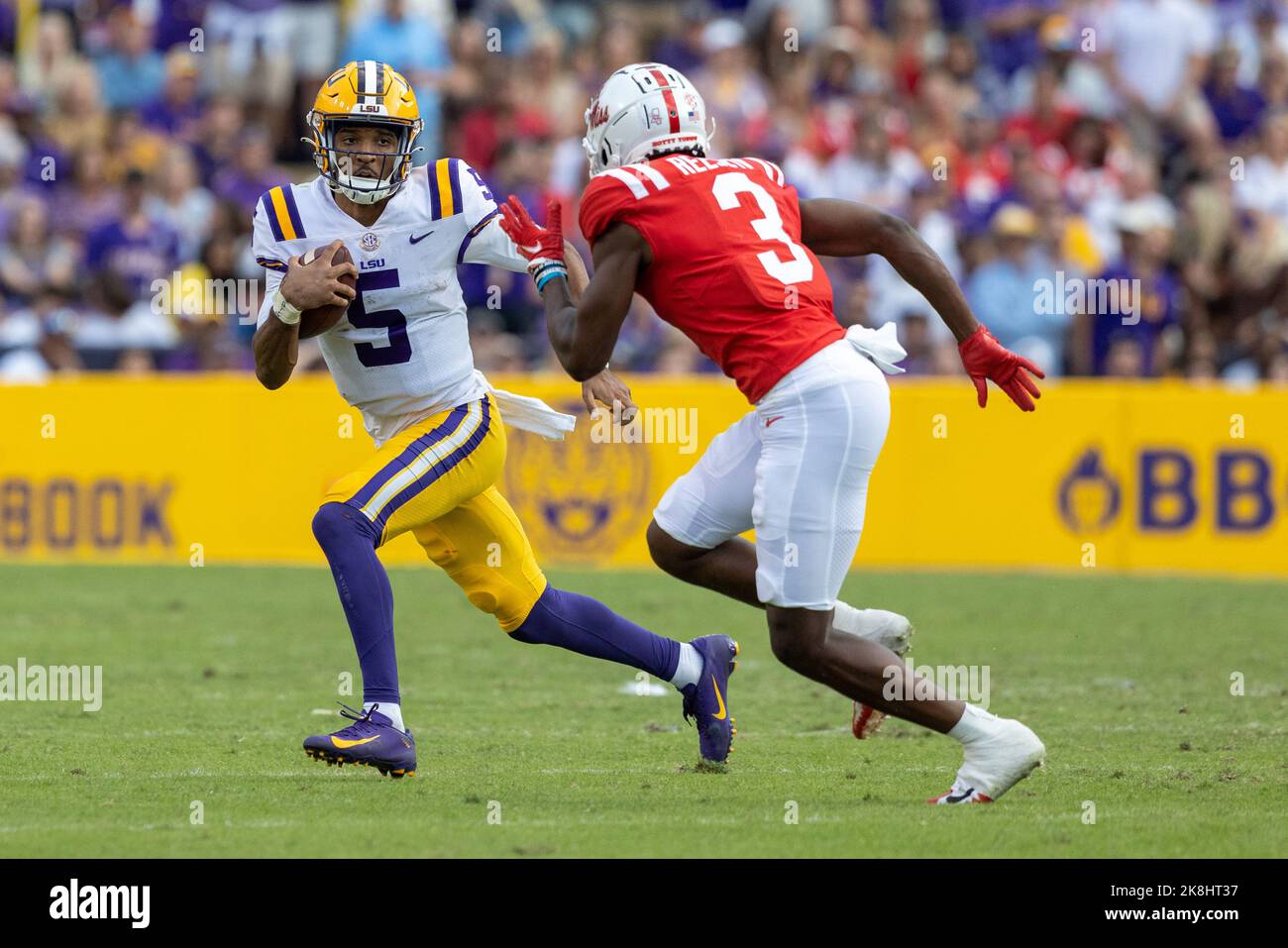 LSU Tigers quarterback Jayden Daniels (5) carries the ball as Ole Miss Rebels safety Otis Reese (3) moves in for a tackle, Saturday, Oct. 22, 2022, in Stock Photo