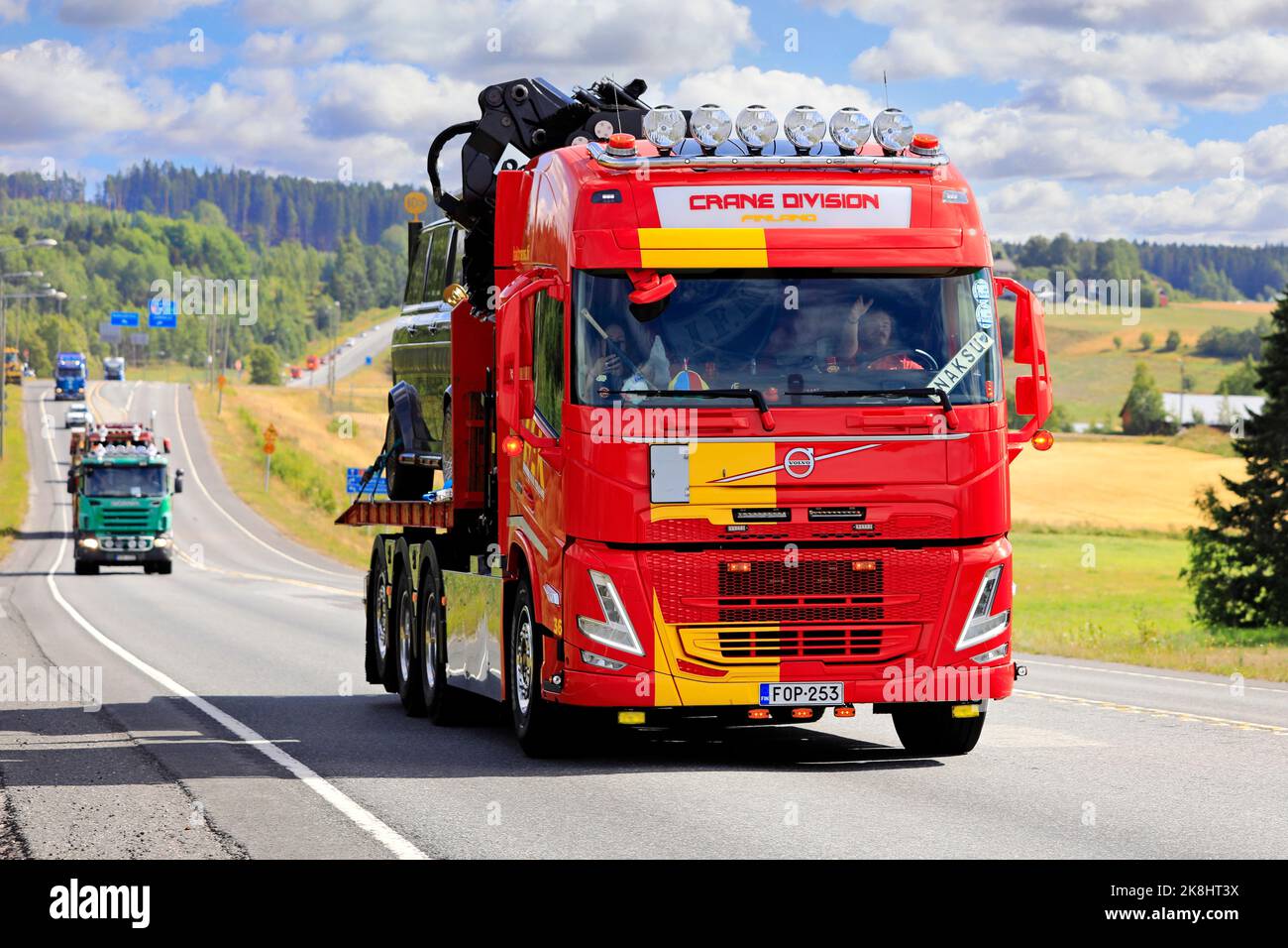 New Volvo flatbed recovery truck with mounted crane in convoy to Power Truck Show. Pirkanmaa, Finland. August 11, 2022. Stock Photo