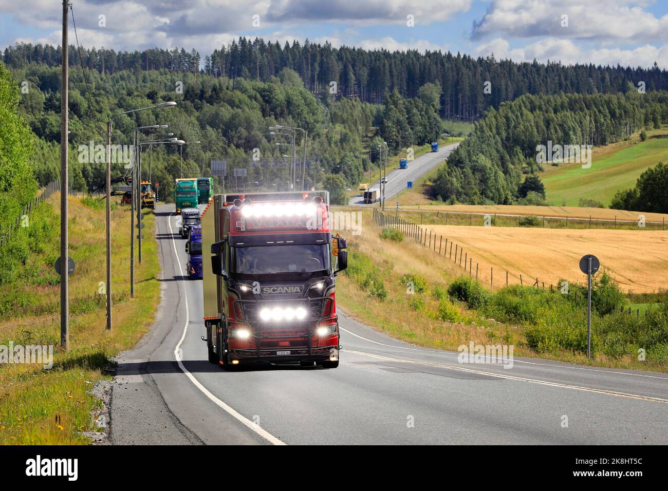 Scania R650 truck semi trailer voWa Transporte, Switzerland with bright headlights in convoy to Power Truck Show. Pirkanmaa, Finland. Aug 11, 2022. Stock Photo
