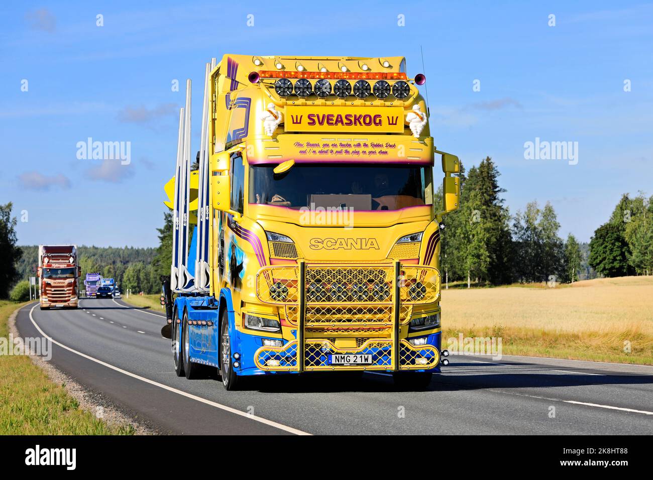 Customised yellow blue Scania R650 timber truck year 2021 of Swenke Transport in truck convoy to Power Truck Show. Urjala, Finland. August 11, 2022. Stock Photo