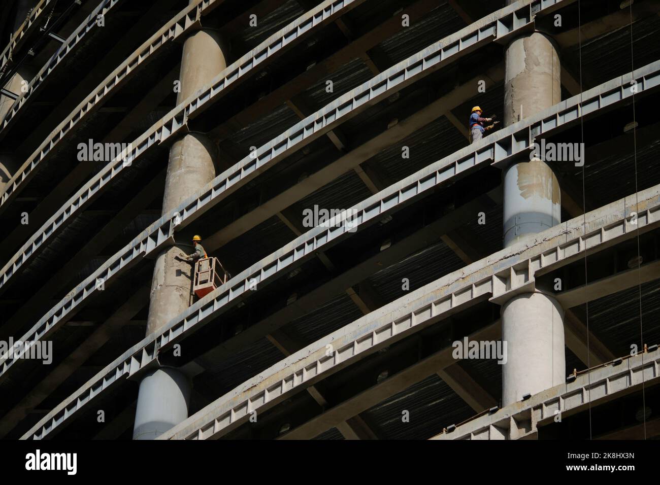 Workers work at a construction site, following the coronavirus disease (COVID-19) outbreak, in Shanghai, China, October 12, 2022. REUTERS/Aly Song Stock Photo