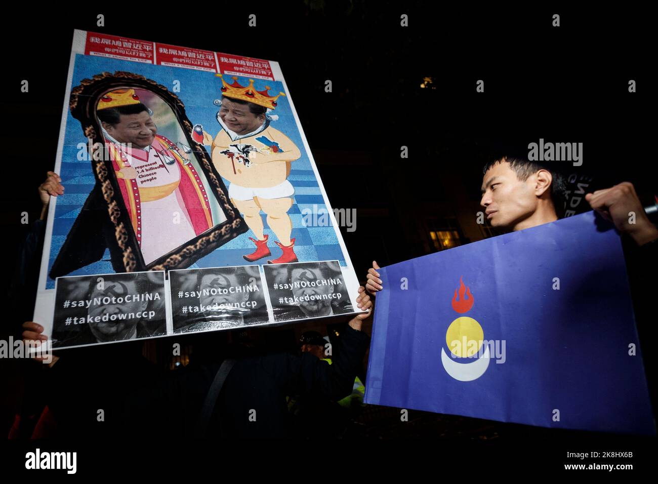 London, UK. 23rd Oct, 2022. Protesters hold placards outside Chinese